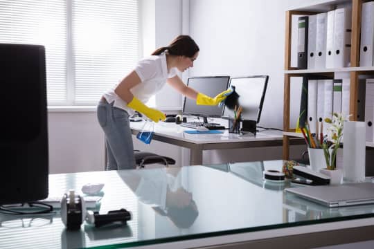 Woman cleaning desk