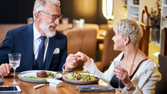 modern older couple having dinner