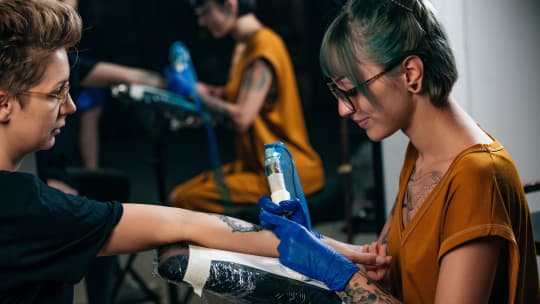 female Tattoo Artist with blue hair