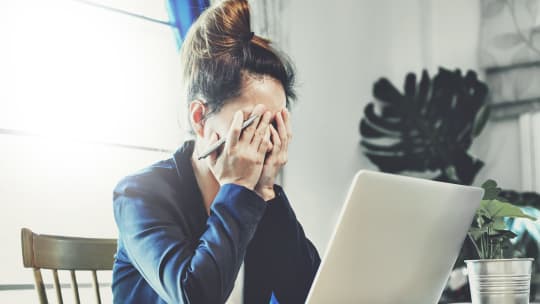 woman crying at her desk at work