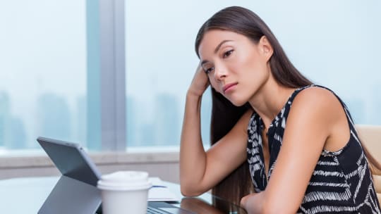 sad woman daydreaming at work