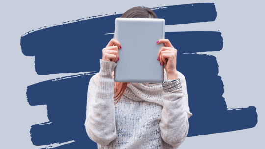 Woman embarrassed hiding behind tablet
