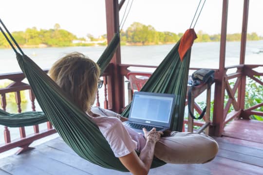 Woman on laptop in hammock