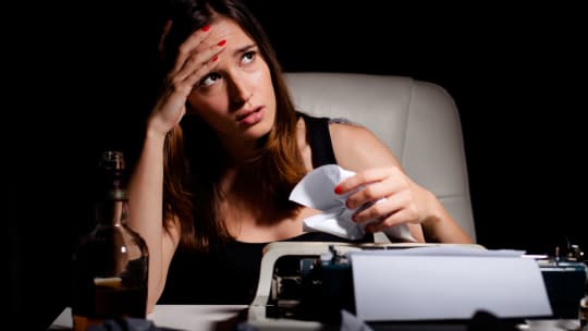 woman with writer's block, frustrated