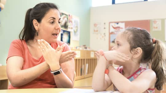 sign language interpreter teaching child sign language