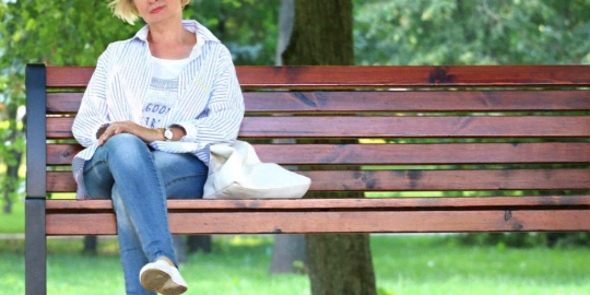 Menopausal woman sitting on bench