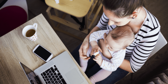 Mom does work with child on lap